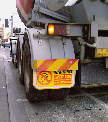 Danger zone Cyclist Beware when vehicle is turning left do not pass on this side 