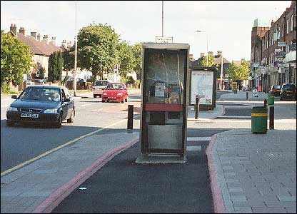 Image of a phonebox planted firmly in the middle of a cycle lane