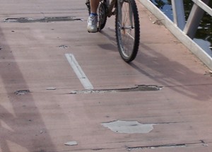 Image of a cyclist tackling the fractured surface of the Church St. ramp